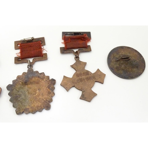 1013 - Militaria: a mid 20thC Chinese PLA medal group, comprising five copper medals and a badge (6)