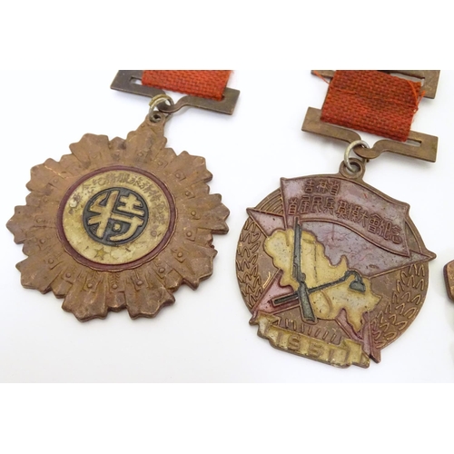 1013 - Militaria: a mid 20thC Chinese PLA medal group, comprising five copper medals and a badge (6)