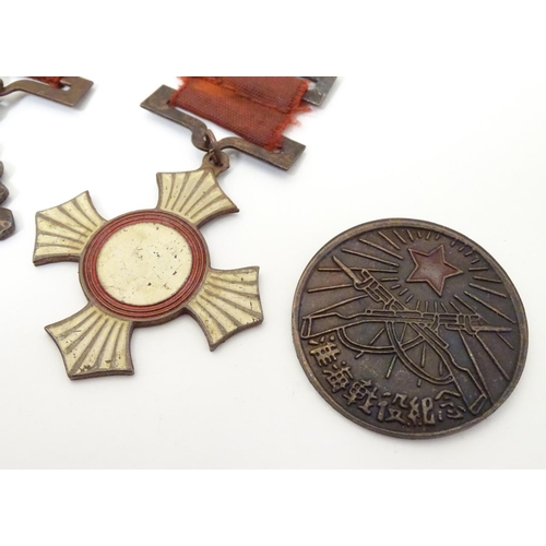 1013 - Militaria: a mid 20thC Chinese PLA medal group, comprising five copper medals and a badge (6)