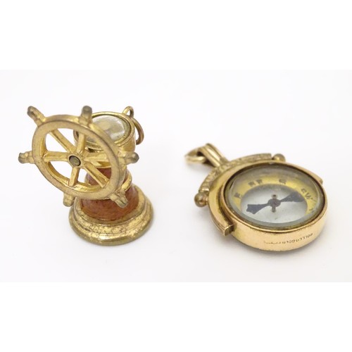 971A - Two gilt metal fobs, one formed as a ships wheel, the other of circular form, both with inset compas... 