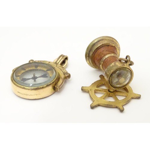 971A - Two gilt metal fobs, one formed as a ships wheel, the other of circular form, both with inset compas... 