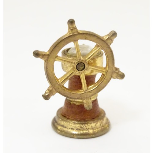 971A - Two gilt metal fobs, one formed as a ships wheel, the other of circular form, both with inset compas... 