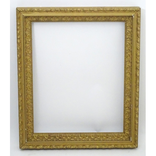 2518 - A 20thC gilt and gesso moulded frame with foliate detail. Approx. 25