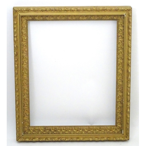 2518 - A 20thC gilt and gesso moulded frame with foliate detail. Approx. 25