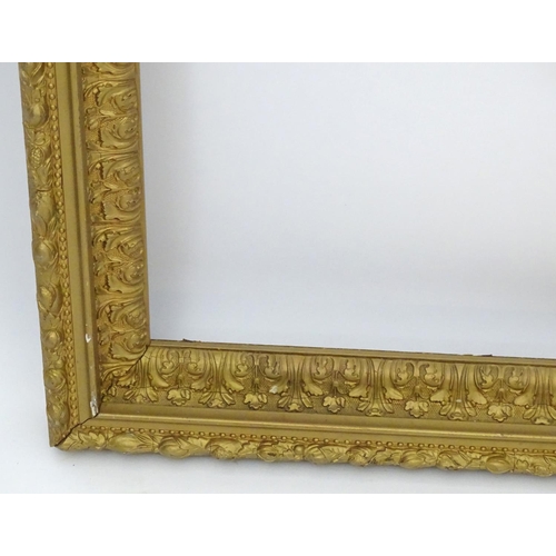 2518 - A 20thC gilt and gesso moulded frame with foliate detail. Approx. 25