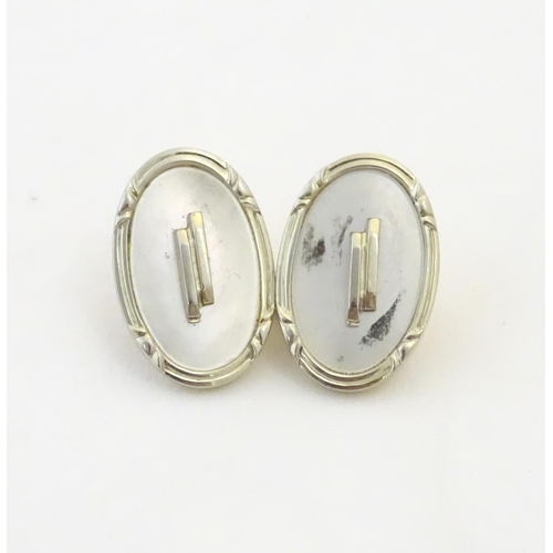 943 - A pair of Art Deco cufflinks with mother of pearl style detail marked 18CT and with makers monogram ... 