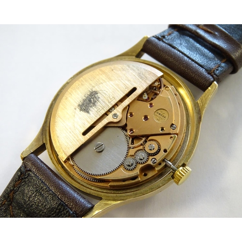 974 - A mid 20thC Omega Geneva automatic chronometer wrist watch with a 9ct gold case. The movement stampe... 