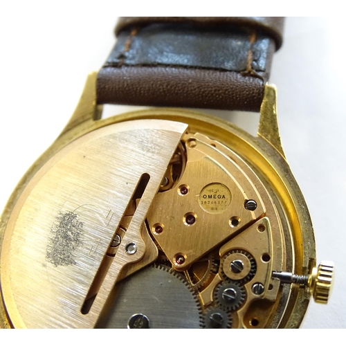 974 - A mid 20thC Omega Geneva automatic chronometer wrist watch with a 9ct gold case. The movement stampe... 