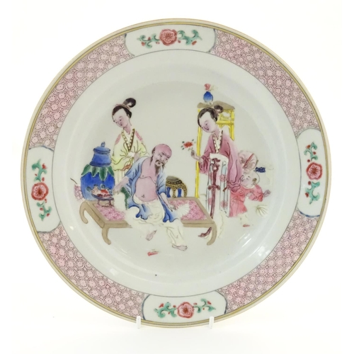 3 - A Chinese famille rose plate decorated with an interior scene with an elderly scholar on a day bed w... 