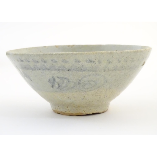 13 - An Oriental earthenware bowl of tapering form with brushwork detail. Approx. 2 1/4