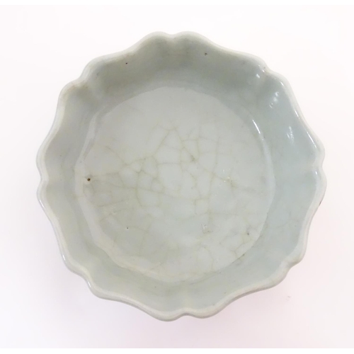 18 - A Chinese celadon brush wash pot with a scalloped edge. Character marks under. Approx. 1 1/2