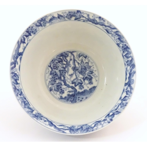 33 - A Chinese blue and white bowl decorated with vine leaves and grapes. Character marks under. Approx. ... 