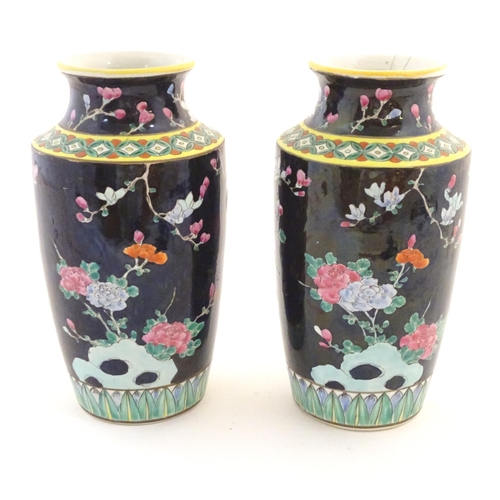 58 - A pair of Oriental vases decorated with stylised pheasants amongst flowers. Character marks under. L... 