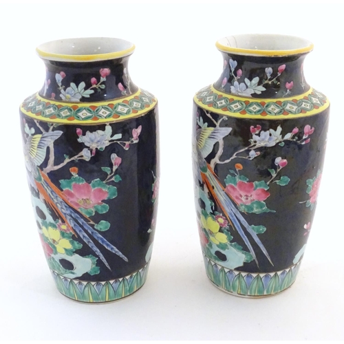 58 - A pair of Oriental vases decorated with stylised pheasants amongst flowers. Character marks under. L... 