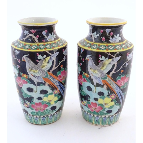 58 - A pair of Oriental vases decorated with stylised pheasants amongst flowers. Character marks under. L... 