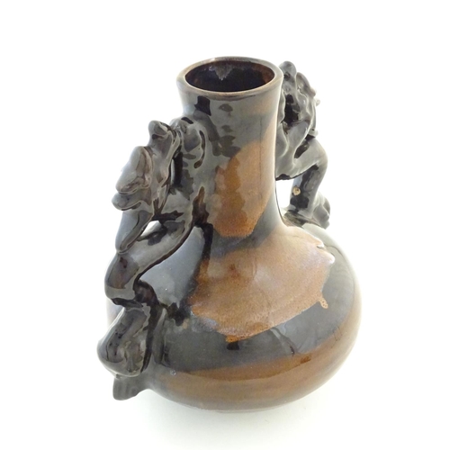 66 - A Oriental twin handled bottle vase with stylised dragon detail to handles. Approx. 10 1/4