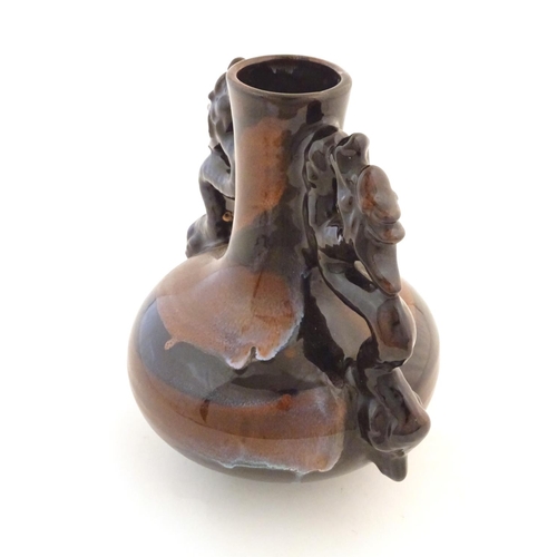 66 - A Oriental twin handled bottle vase with stylised dragon detail to handles. Approx. 10 1/4