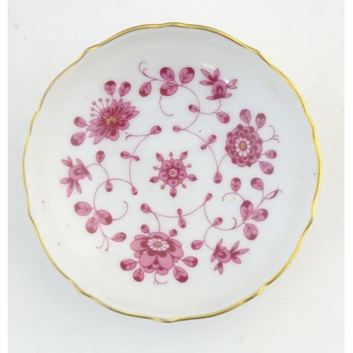 75 - A Nymphenburg plate with a scallop edge and flower detail, marked under. Together with a West German... 