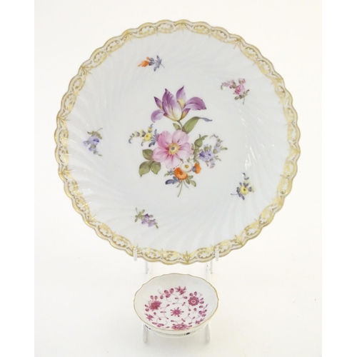 75 - A Nymphenburg plate with a scallop edge and flower detail, marked under. Together with a West German... 