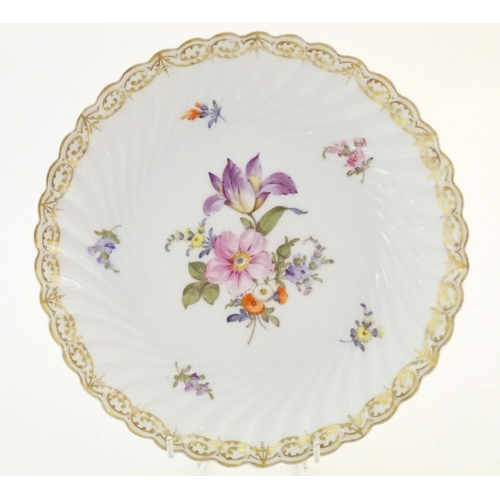 75 - A Nymphenburg plate with a scallop edge and flower detail, marked under. Together with a West German... 