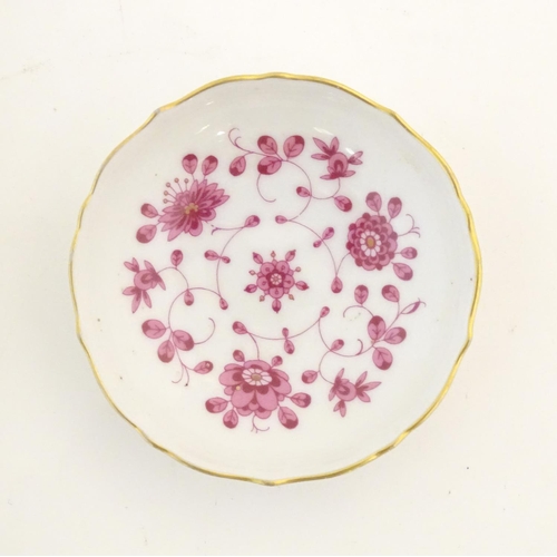 75 - A Nymphenburg plate with a scallop edge and flower detail, marked under. Together with a West German... 