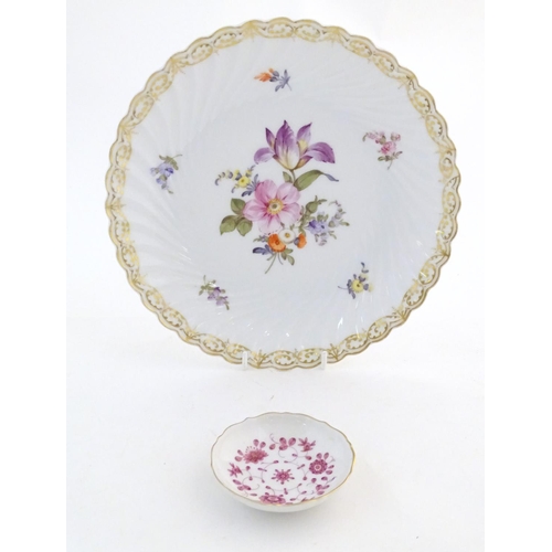 75 - A Nymphenburg plate with a scallop edge and flower detail, marked under. Together with a West German... 