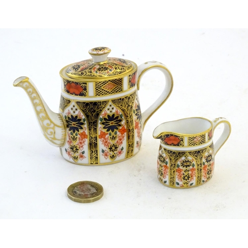 118 - Two Royal Crown Derby wares in the Imari palette, comprising a miniature teapot and milk jug. Marked... 