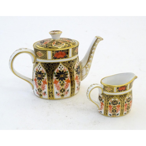 118 - Two Royal Crown Derby wares in the Imari palette, comprising a miniature teapot and milk jug. Marked... 