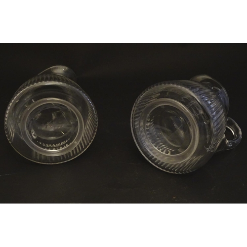 269 - A pair of late 19thC glass jugs, decorated with etched necks and bladed flute cuts, each 5 1/2