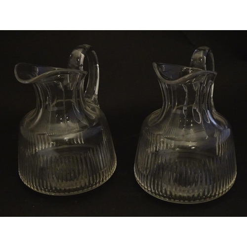 269 - A pair of late 19thC glass jugs, decorated with etched necks and bladed flute cuts, each 5 1/2