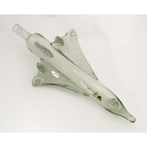 303 - A novelty glass decanter / bottle in the form of Concorde / delta wing jet / aeroplane, 16