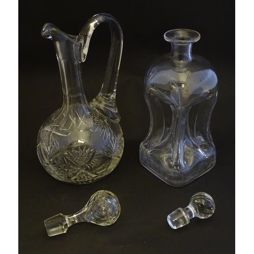 307 - A 19thC pinched crystal decanter, the stopper with swirl decoration, together with a 19thC claret ju... 