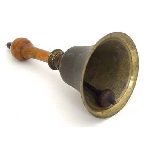 1170 - A 20thC hand bell with a turned wooden handle and acorn finial. Approx. 10 1/4