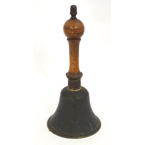 1170 - A 20thC hand bell with a turned wooden handle and acorn finial. Approx. 10 1/4