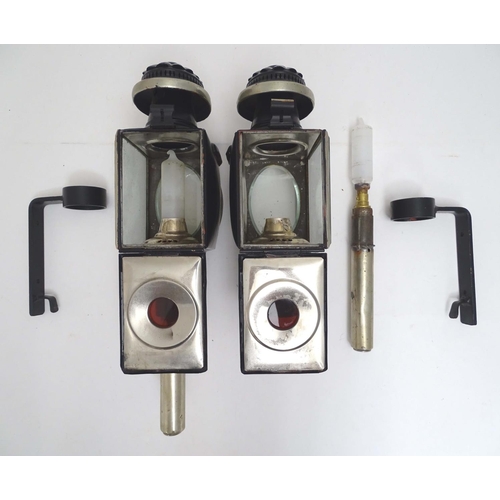 1198 - A pair of 20thC coaching style lamps / wall lights, with tin frames, glass panels and steel brackets... 