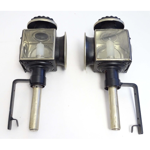 1198 - A pair of 20thC coaching style lamps / wall lights, with tin frames, glass panels and steel brackets... 