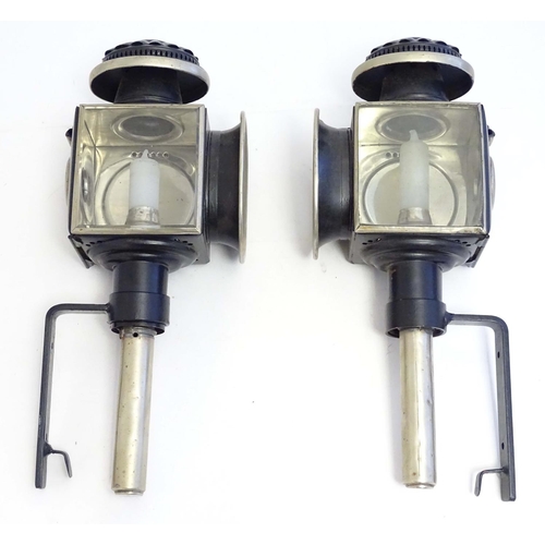 1198 - A pair of 20thC coaching style lamps / wall lights, with tin frames, glass panels and steel brackets... 