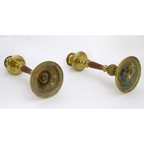 1224 - A pair of 19thC brass candlesticks with copper reeded columns. Approx. 10 1/2