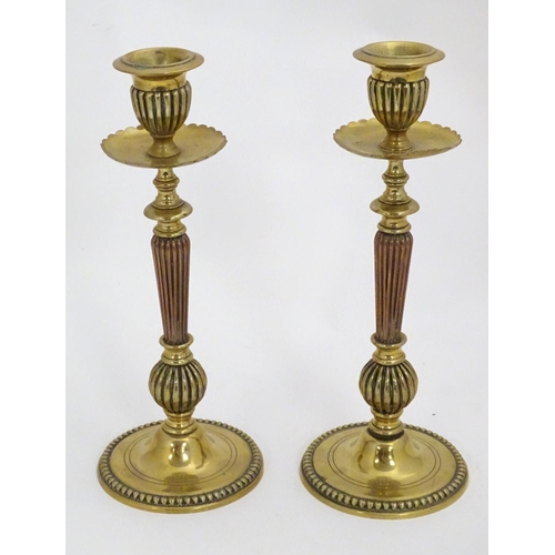 1224 - A pair of 19thC brass candlesticks with copper reeded columns. Approx. 10 1/2