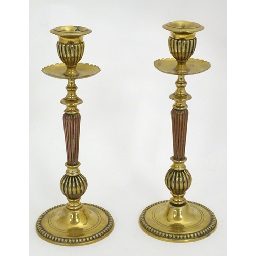 1224 - A pair of 19thC brass candlesticks with copper reeded columns. Approx. 10 1/2