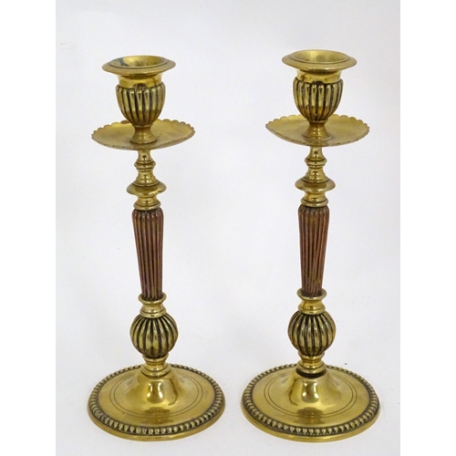 1224 - A pair of 19thC brass candlesticks with copper reeded columns. Approx. 10 1/2