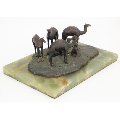 1225 - A late 19th / early 20thC bronze sculpture depicting camels and a seated Arabic man, mounted on an o... 