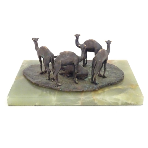 1225 - A late 19th / early 20thC bronze sculpture depicting camels and a seated Arabic man, mounted on an o... 