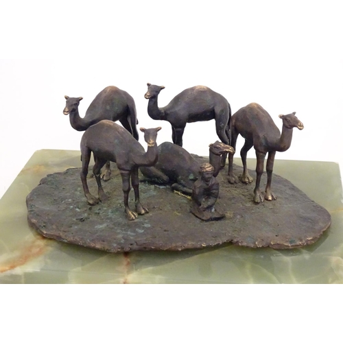 1225 - A late 19th / early 20thC bronze sculpture depicting camels and a seated Arabic man, mounted on an o... 