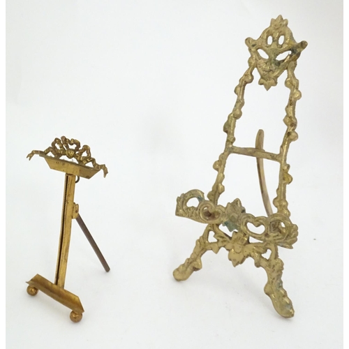 1226 - Two 19thC cast brass table top easels, one with floral and foliate detail, the other surmounted by r... 