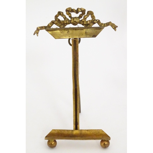 1226 - Two 19thC cast brass table top easels, one with floral and foliate detail, the other surmounted by r... 