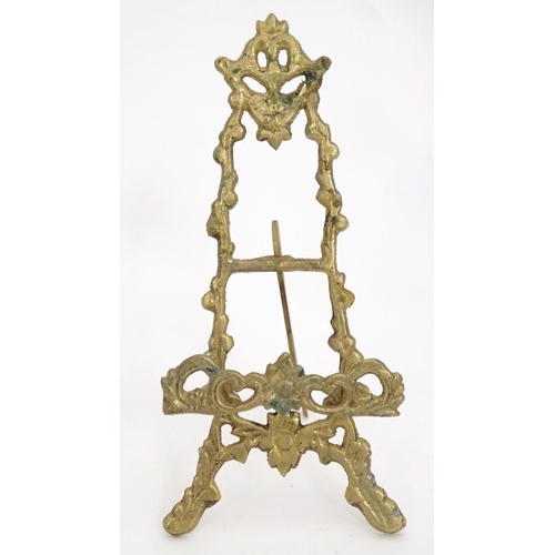 1226 - Two 19thC cast brass table top easels, one with floral and foliate detail, the other surmounted by r... 