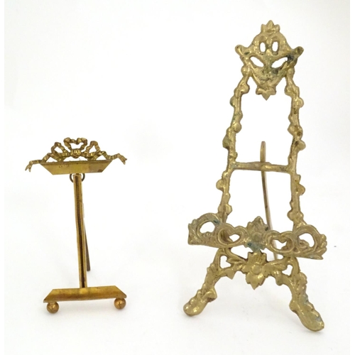 1226 - Two 19thC cast brass table top easels, one with floral and foliate detail, the other surmounted by r... 