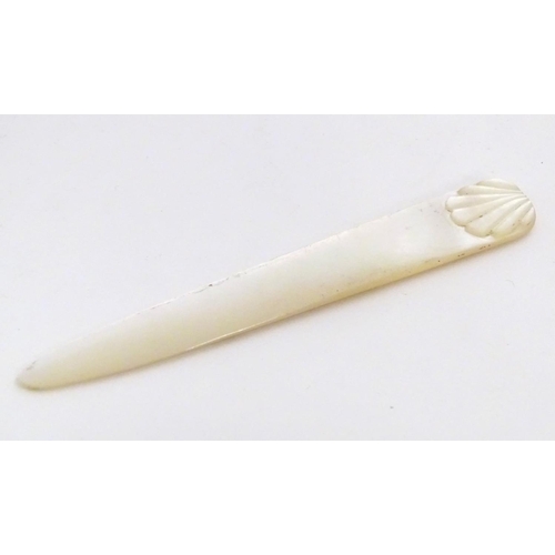 1229 - An early 20thC mother of pearl letter opener with shell detail. Approx. 4 1/4