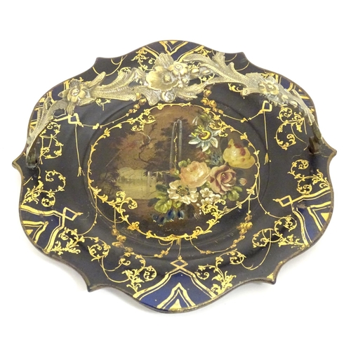 1233 - A Victorian papier mache dish with swing handle with lacquered and painted decoration depicting flow... 